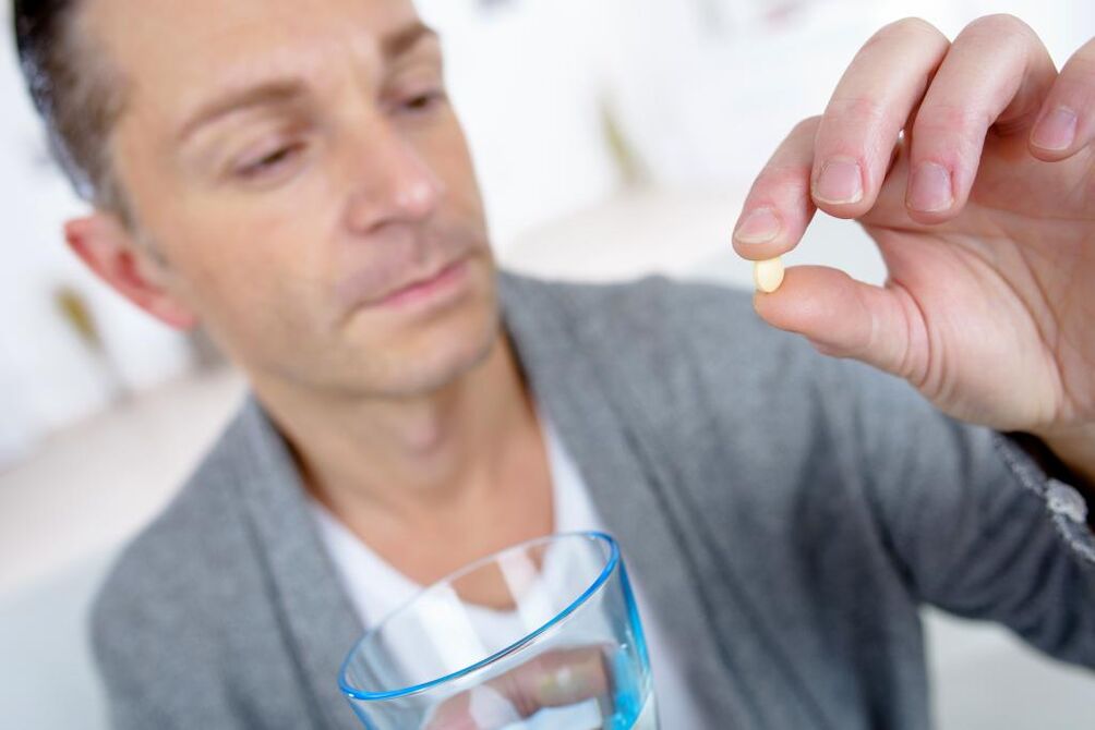 man takes a pill to increase potency